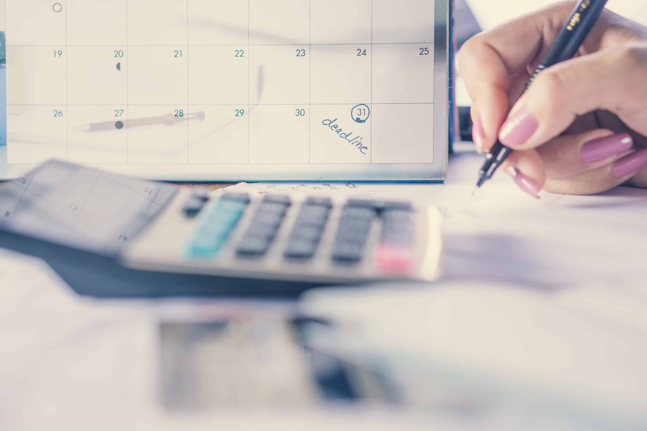 business-woman-hand-calculating-her-monthly-expenses-with-credit-card-idea-for-shopping-online-debt-and-payment-concept-background-selective-focus-on-deadline-calendar-note